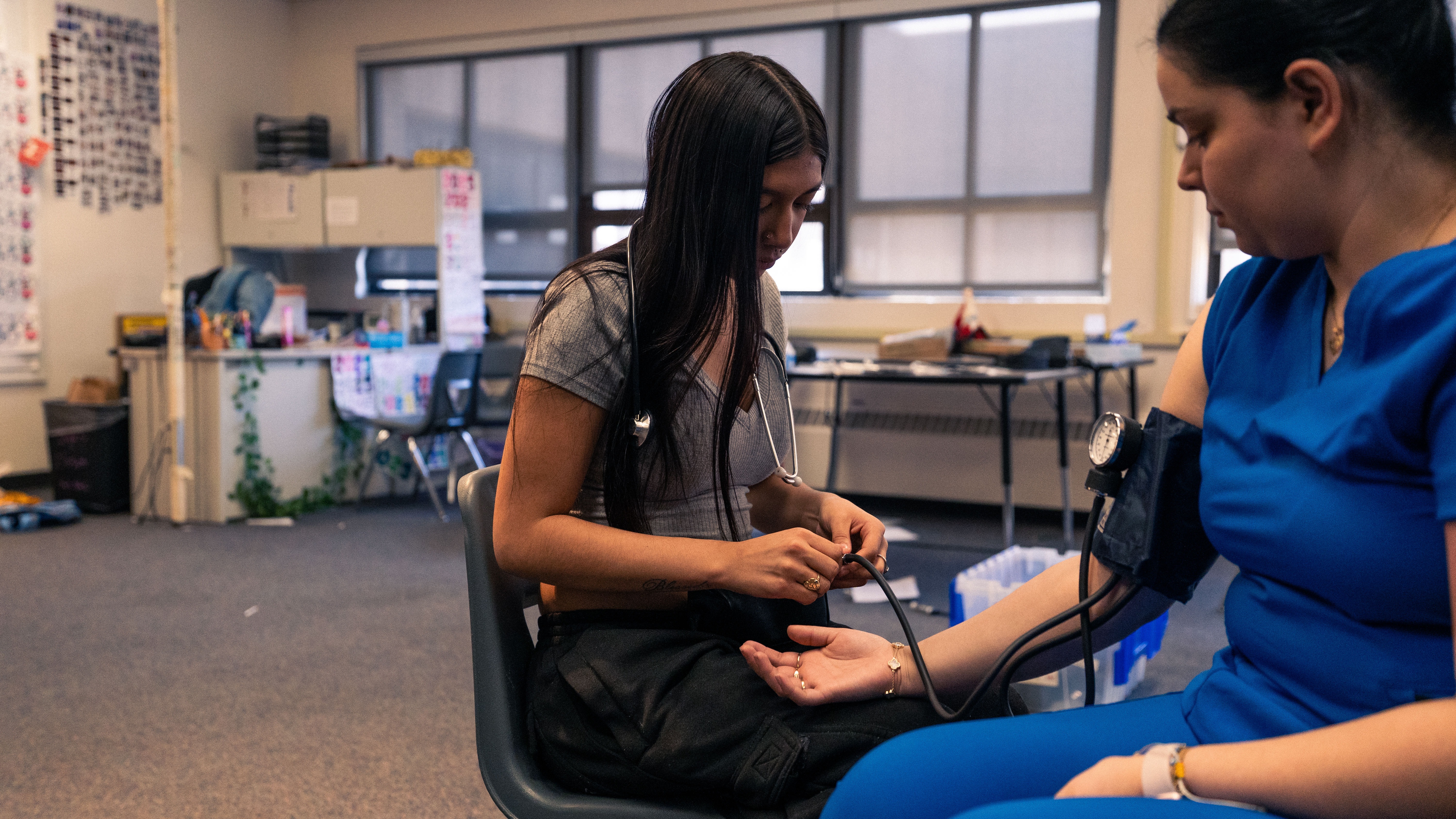 Introduction to Medical Careers student is taking a blook pressure reaching of another person