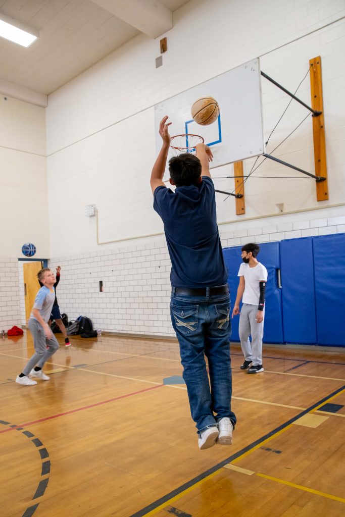 boy throwing basketball