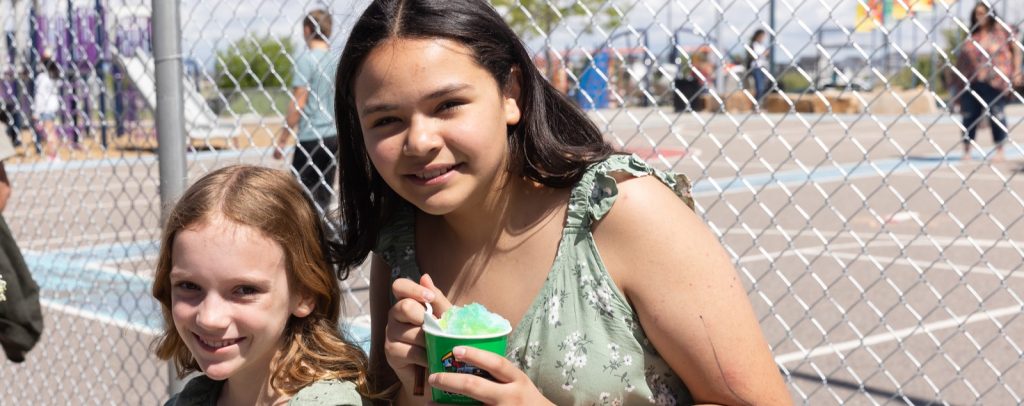 two girls smiling to camera