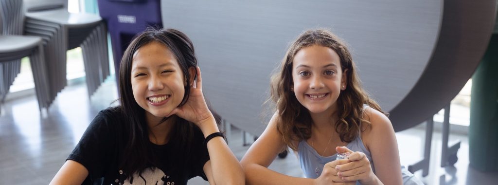 two girls smiling to camera