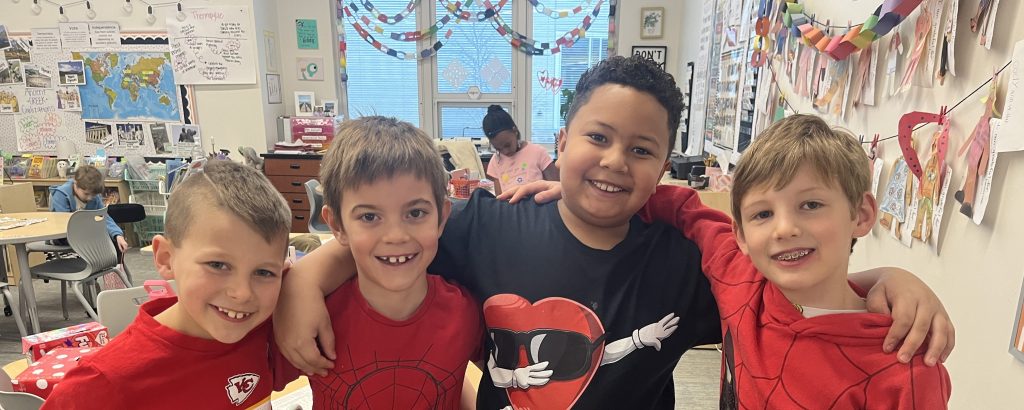 4 kids smiling to camera