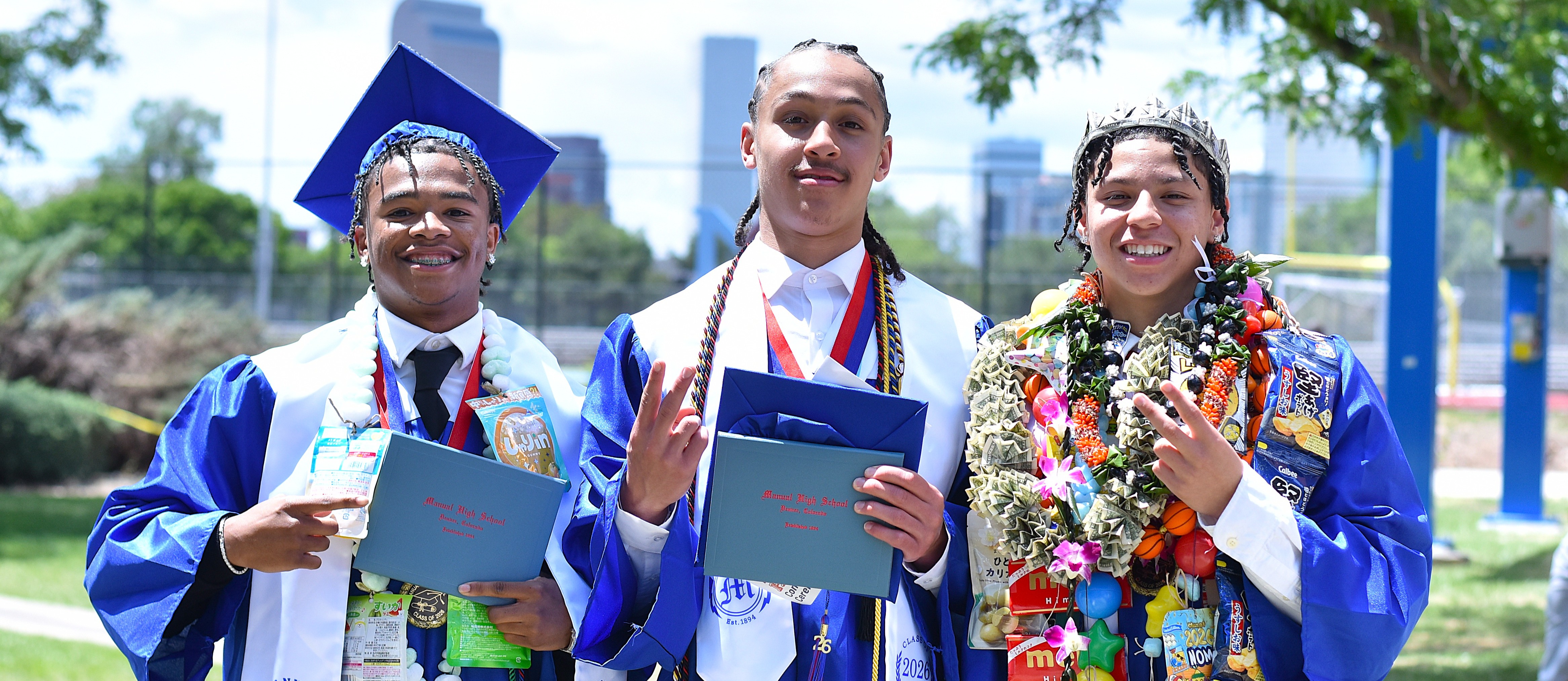 Students smile in their caps and gowns