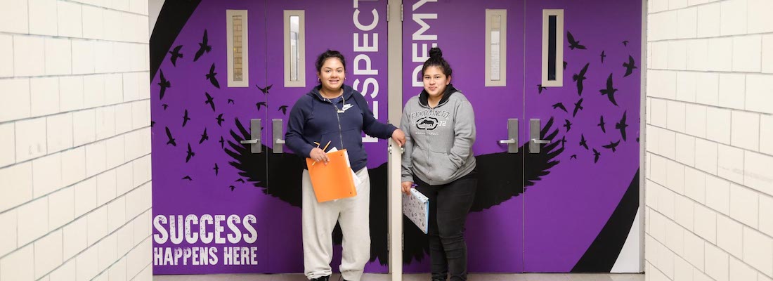 two students smiling to camera