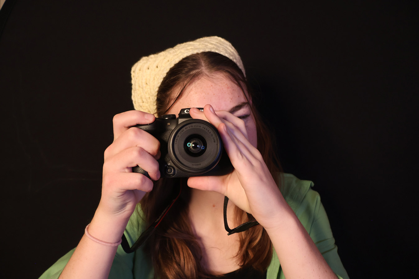 student holding up camera