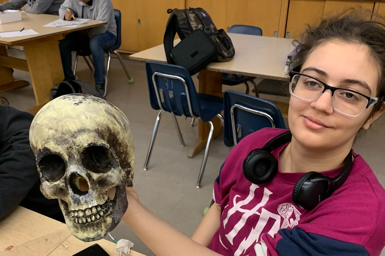 Student showing skull made  in art class