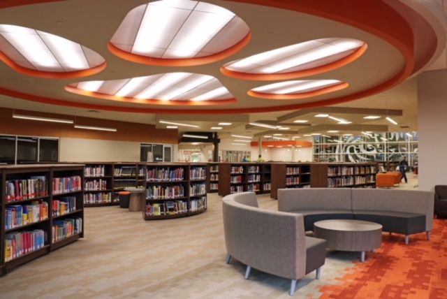 Picture of Norman High Library includes shelves of books and comfortable seating.