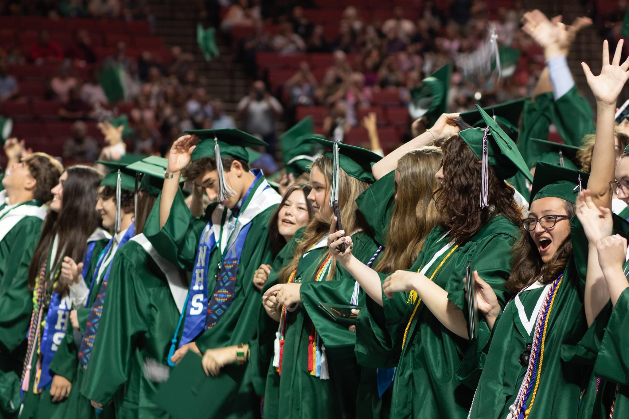 Students get ready to toss their caps at the 2024 NNHS Graduation Ceremony
