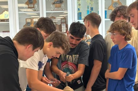 Boys intibating a dummy