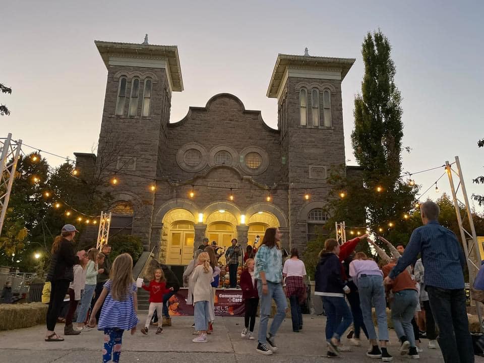 Outside front of the Tabernacle lit up (literally and a figuratively) with community members dancing to local folk band on front of the bldg. 