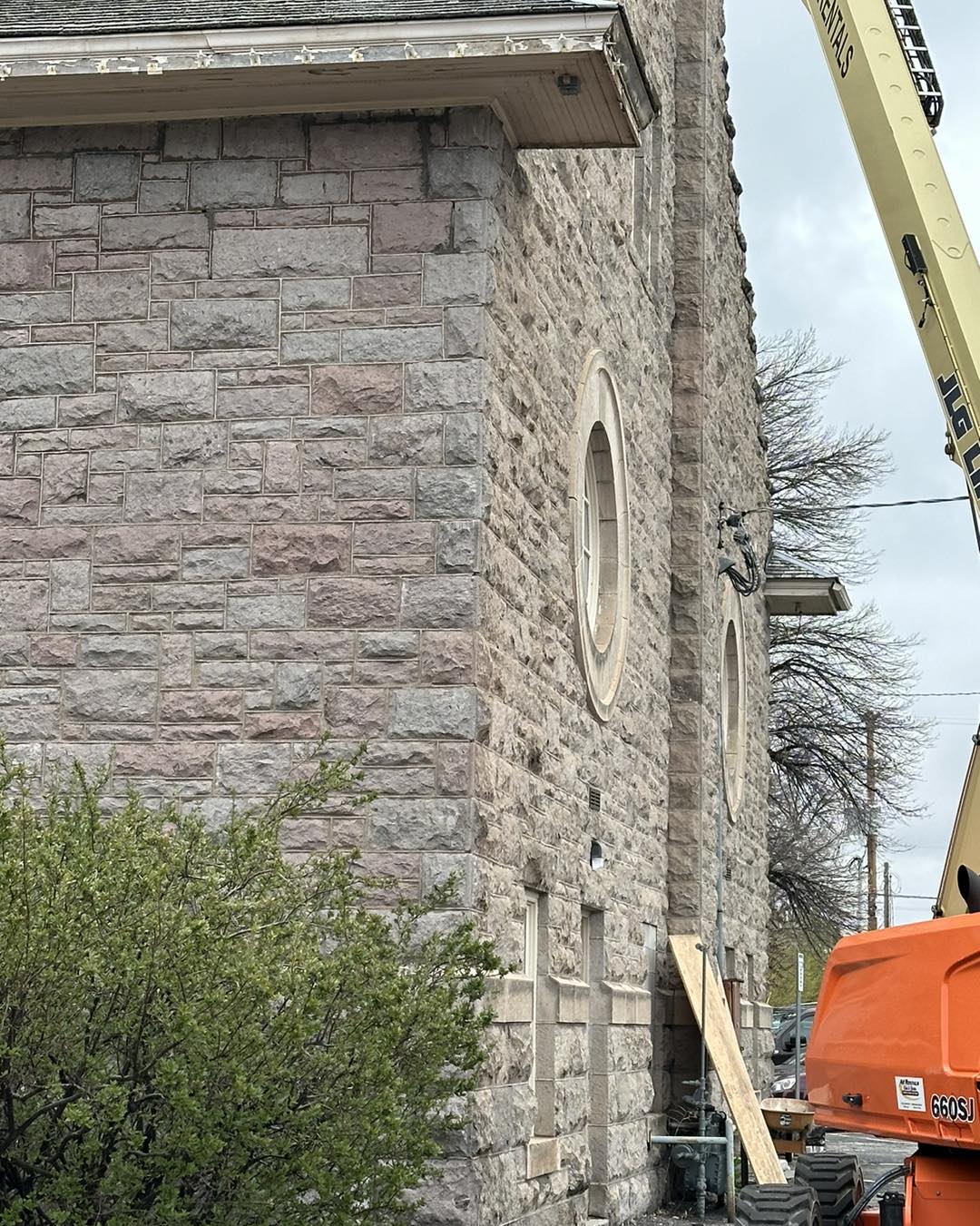 closeup of the stonework in spring of 2024 during restoration shows one side with cleaned stones and one side with uncleaned stones.