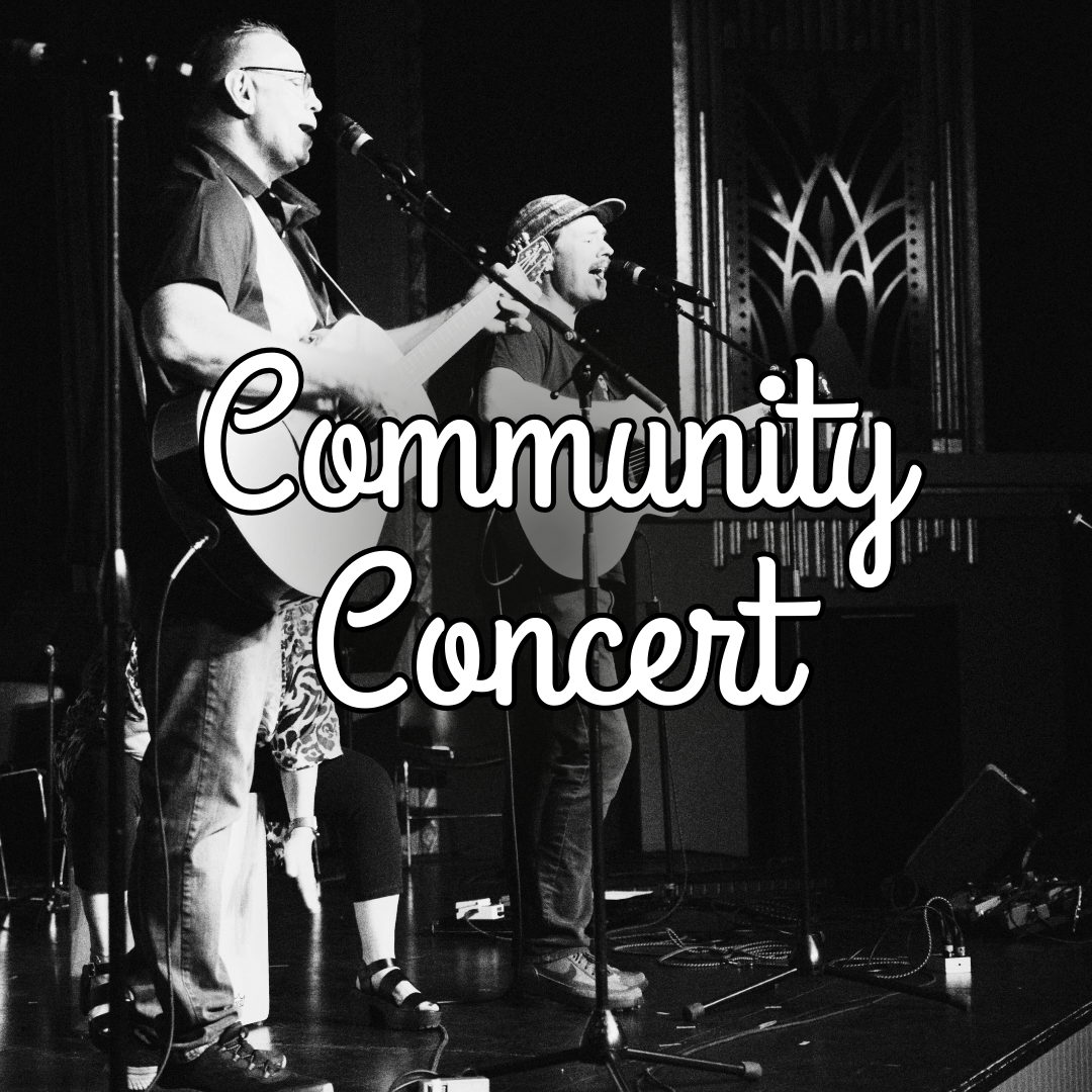 B&W photo of two adult men with guitars singing and performing on stage at the Romance Theater