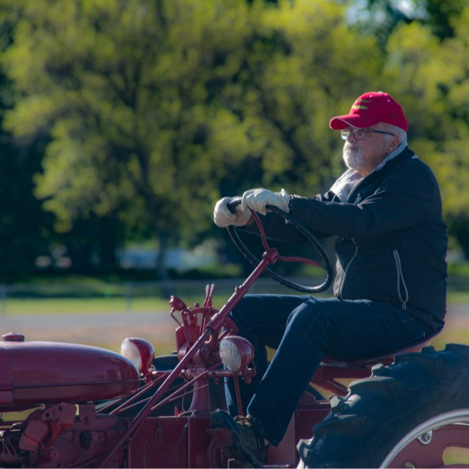 Man on a red vintage tractor