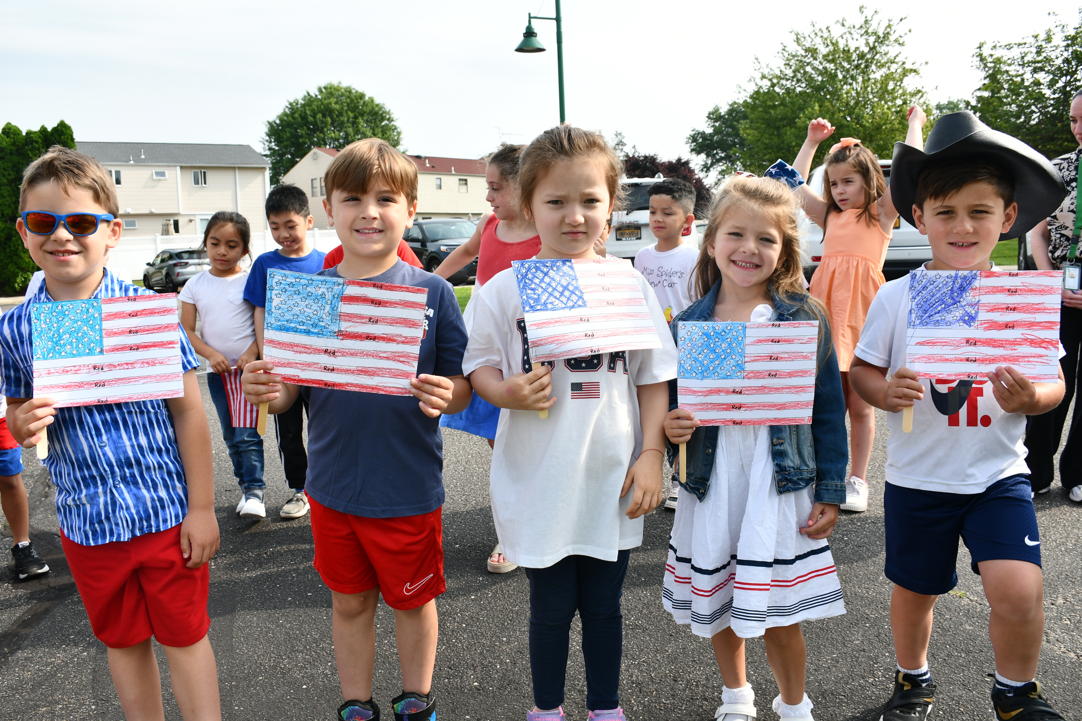 Students holding American Flag drawings
