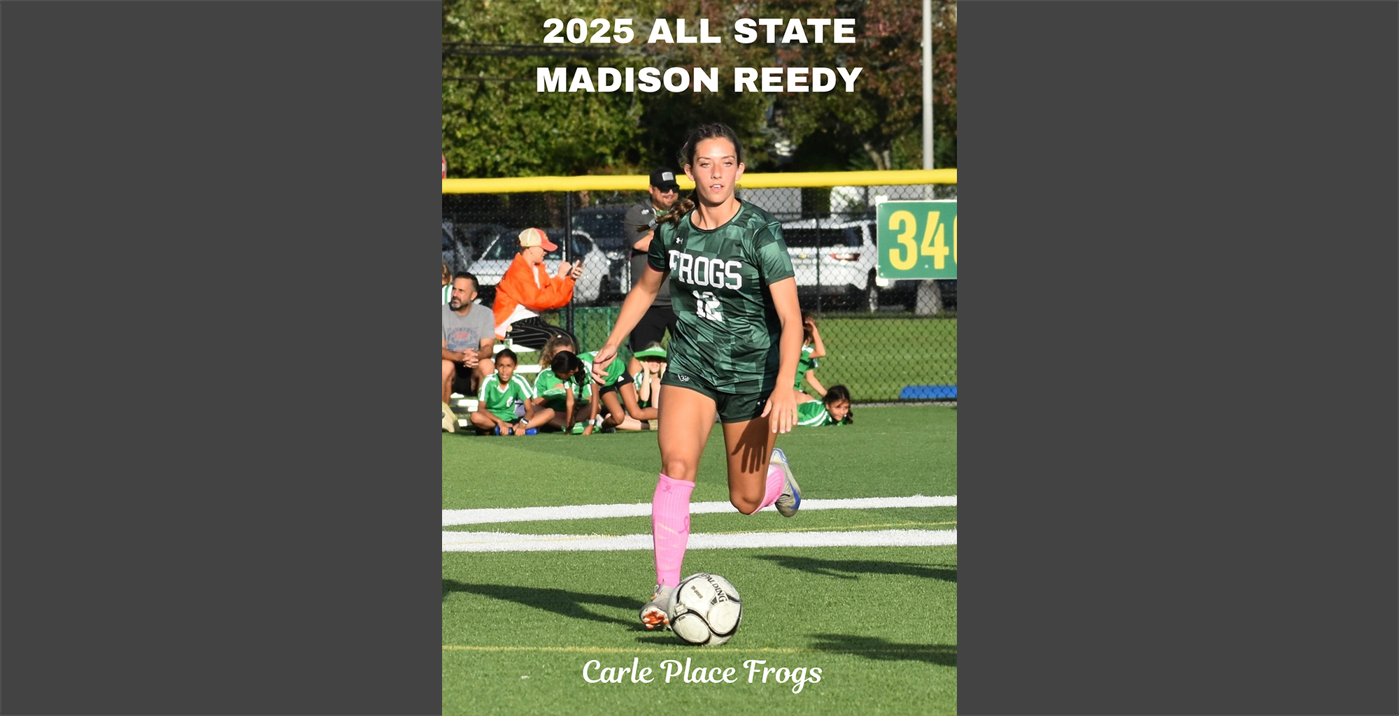 A female soccer player in a green "Frogs" jersey with the number 12 dribbles a ball on a field. 