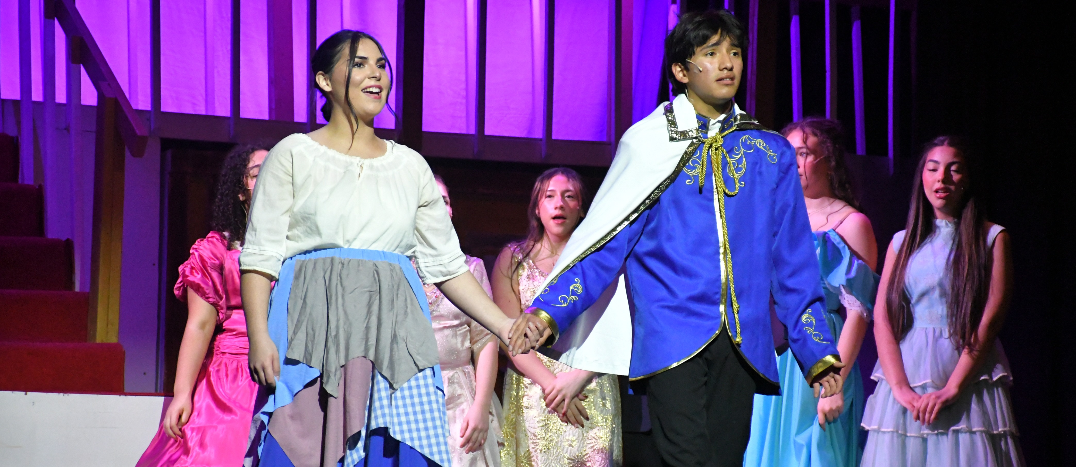 Students in costume on stage.