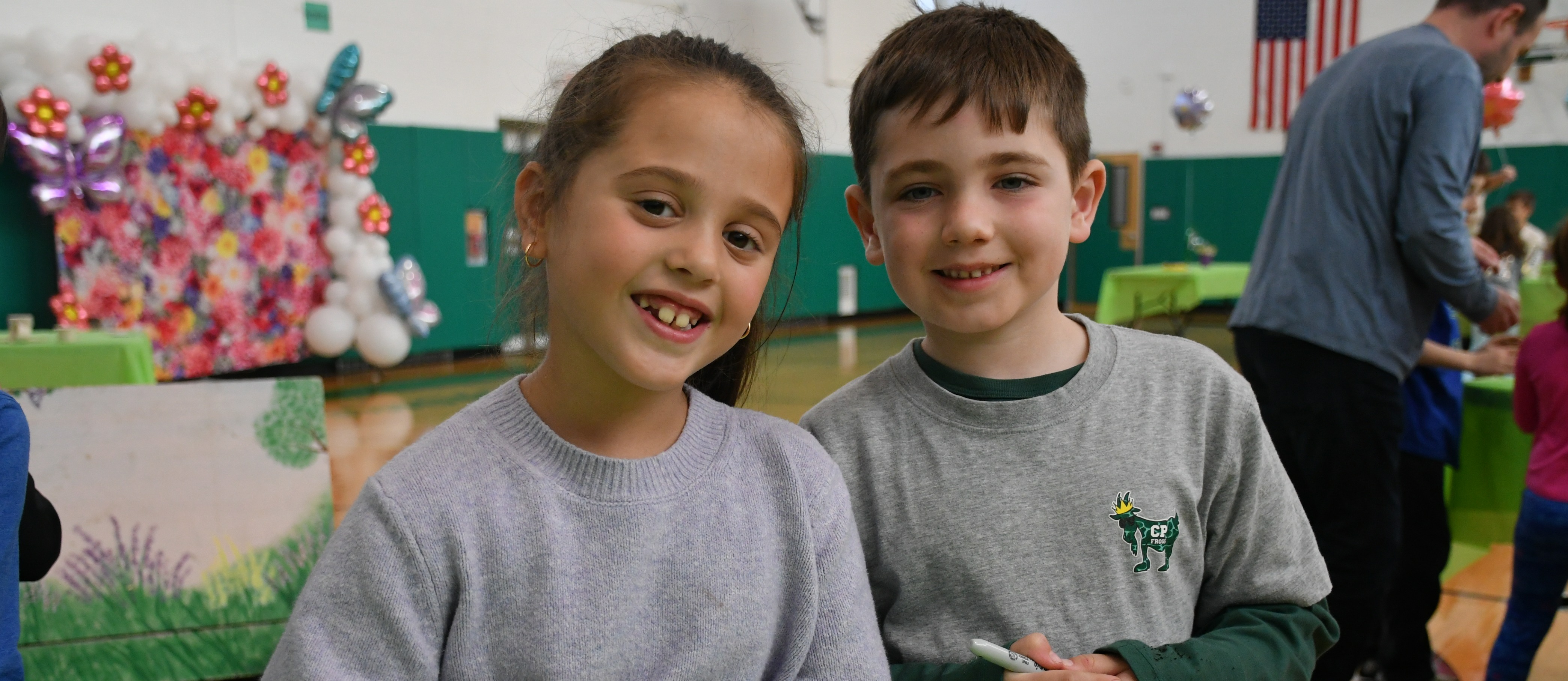 Carle Place students smiling at camera.