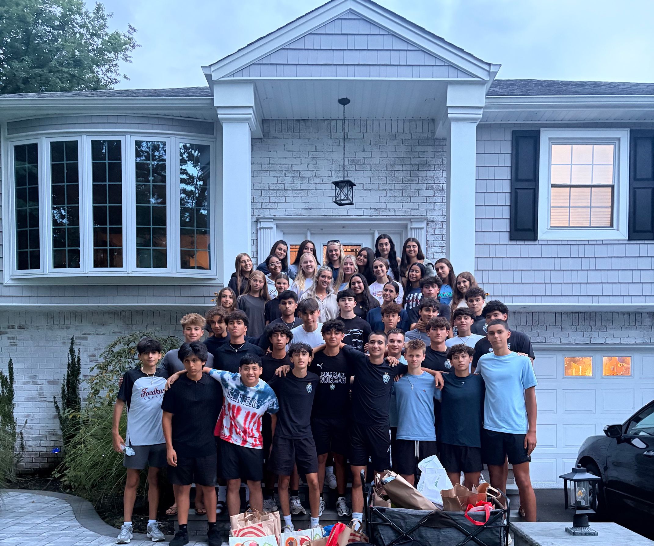 Students standing outside historic building.