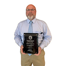photo of Chad Jepsen holding Excellence Plaque for Administrator of the Year