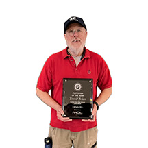 Tim O'Brien holding plaque Custodian of the Year award by MCL Construction
