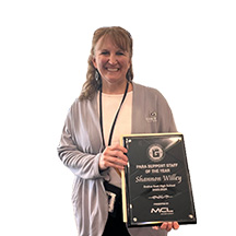 Shannon Willey holding plaque from MCL Construction