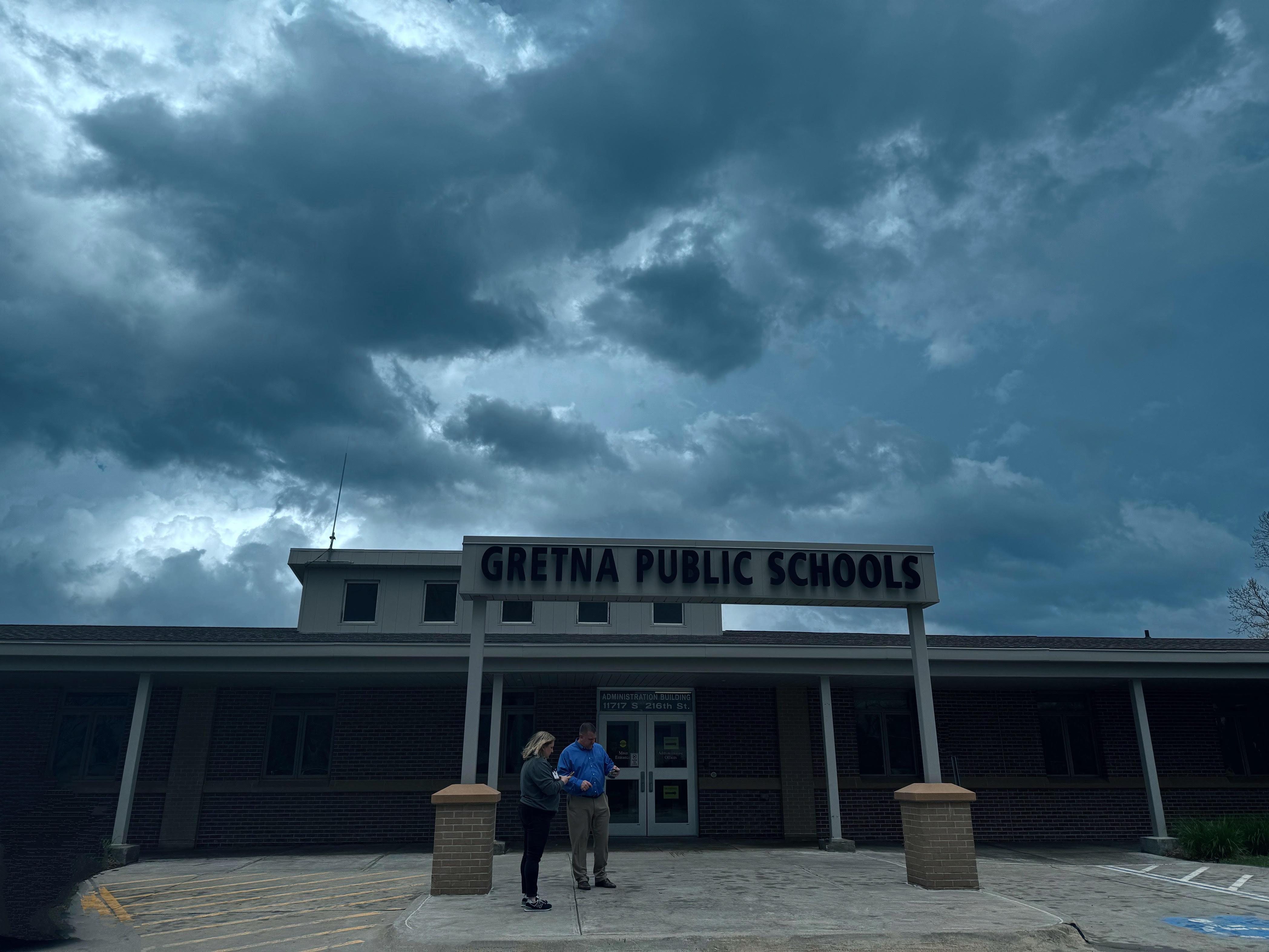 Gretna Public Schools Administration building with storm clouds over the sign.