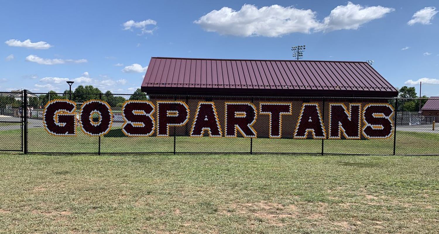 sign in fence that says "Go Spartans"