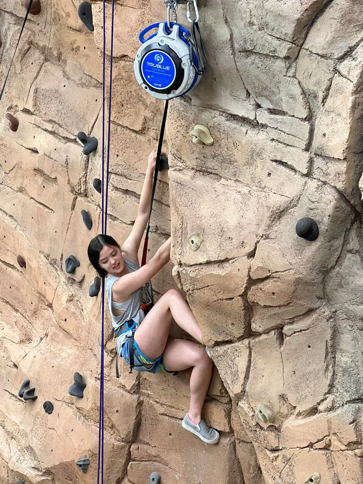 student rock wall climbing