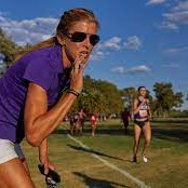 coach on side of trail coaching runners in purple top