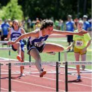 young girl running hurdles