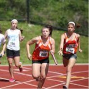 girls in a relay race passing off the baton