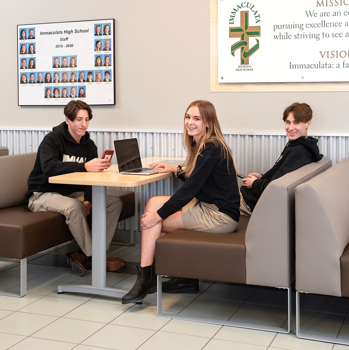 three students seated on the cafeteria booth