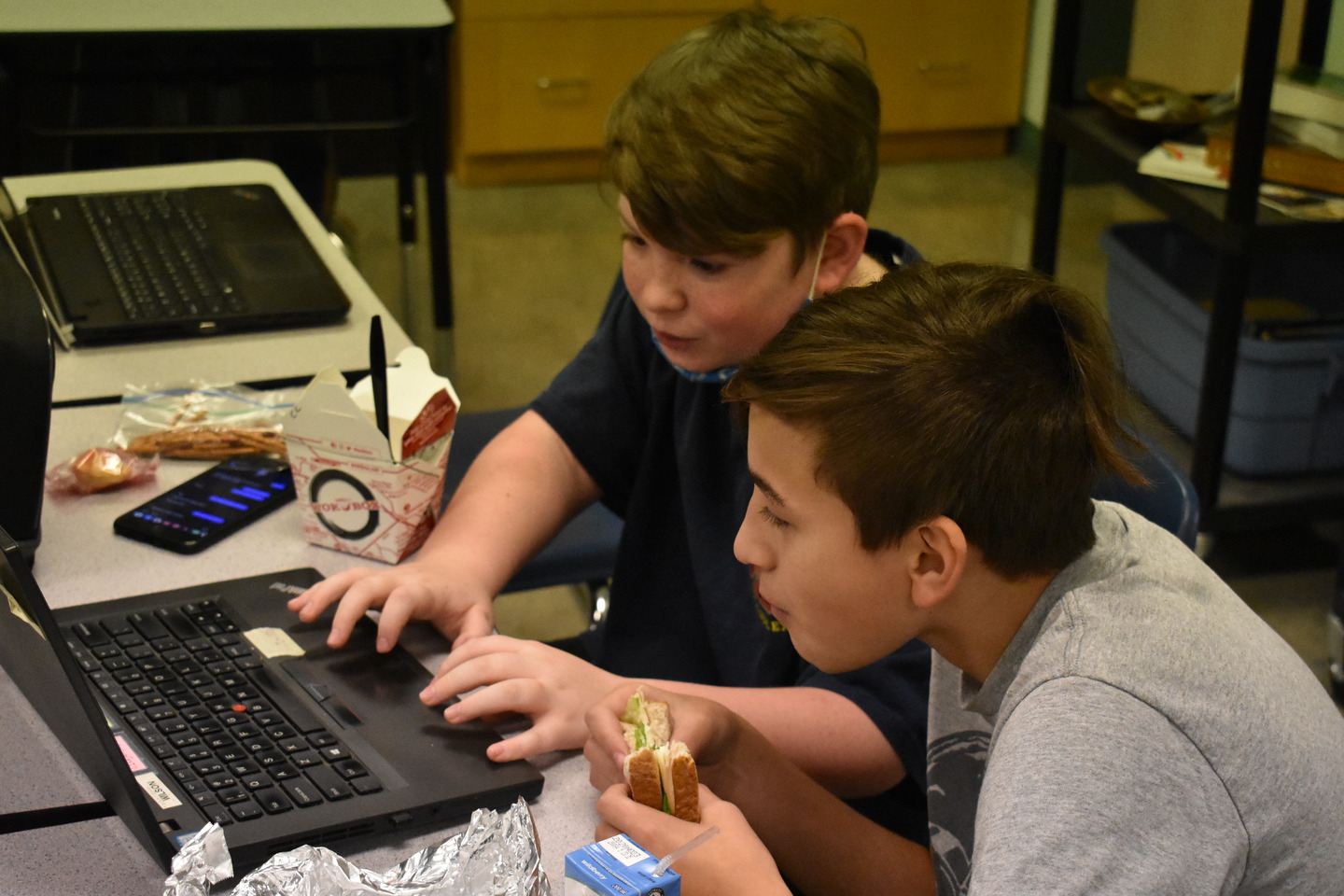 two students working on something on a computer
