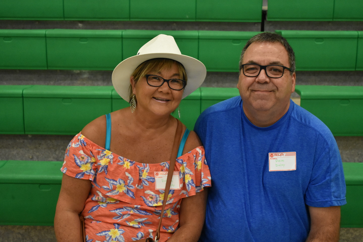 two teachers smiling to the camera inside the school campus