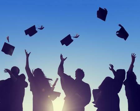 graduated students throwing their hats