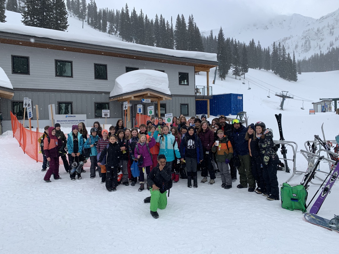 group of students on a mountain hill about to skii