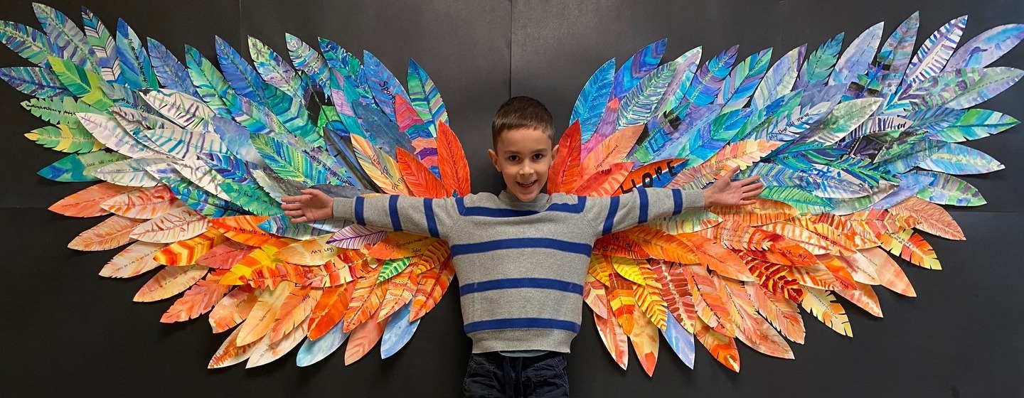 boy student with wings on a wall