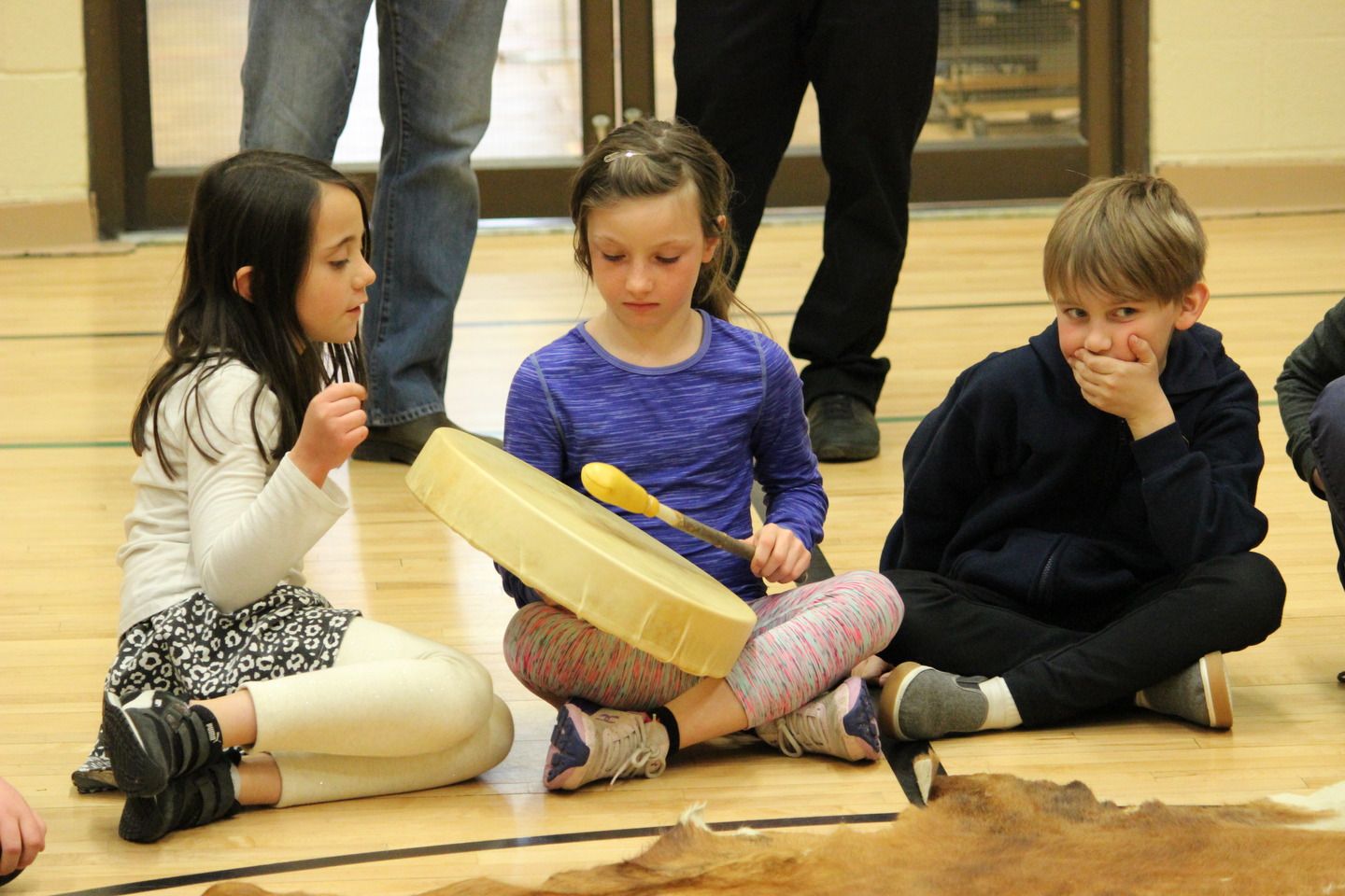 young students using the hand drum