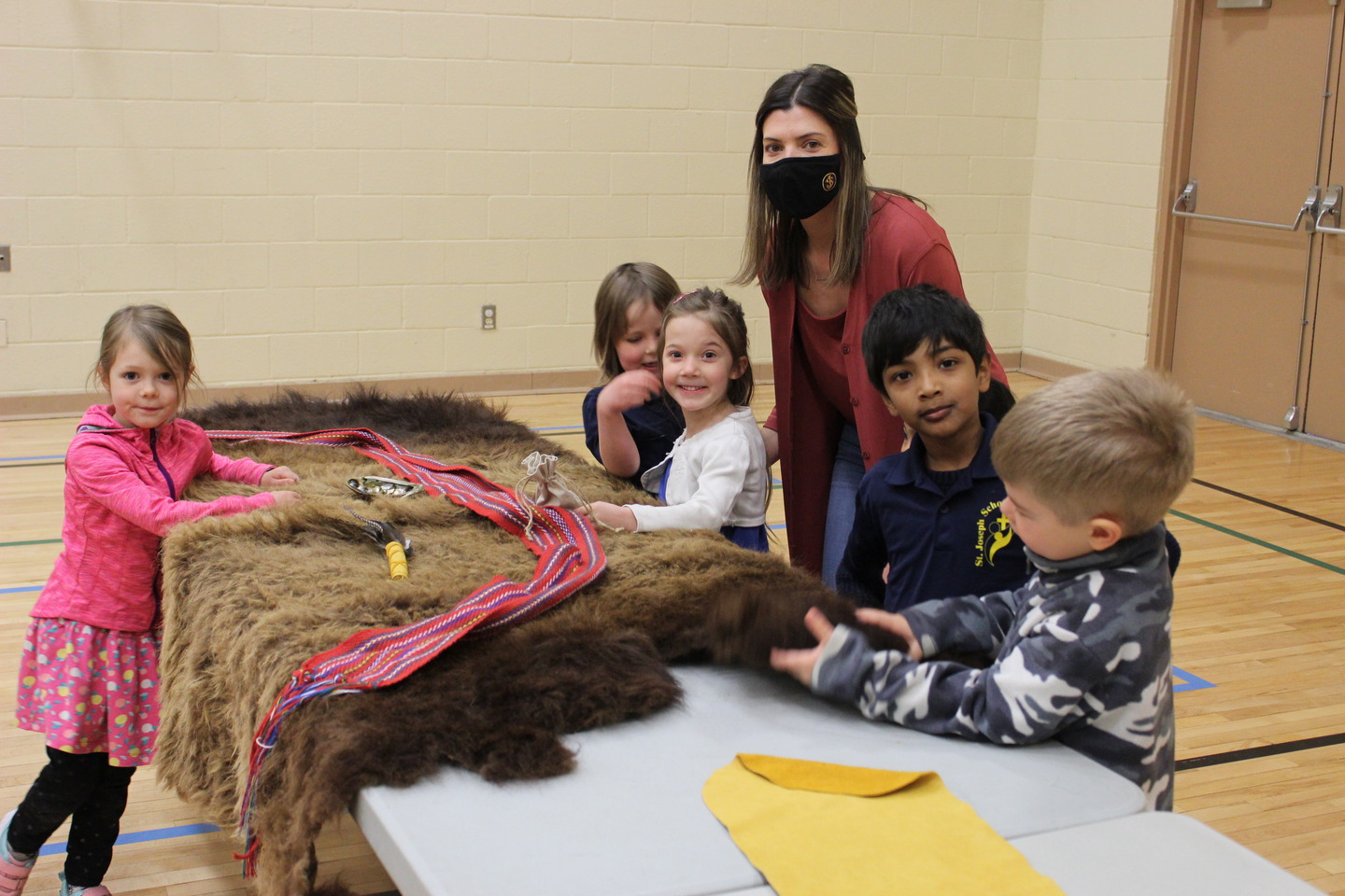 students with animal faux fur and their teacher