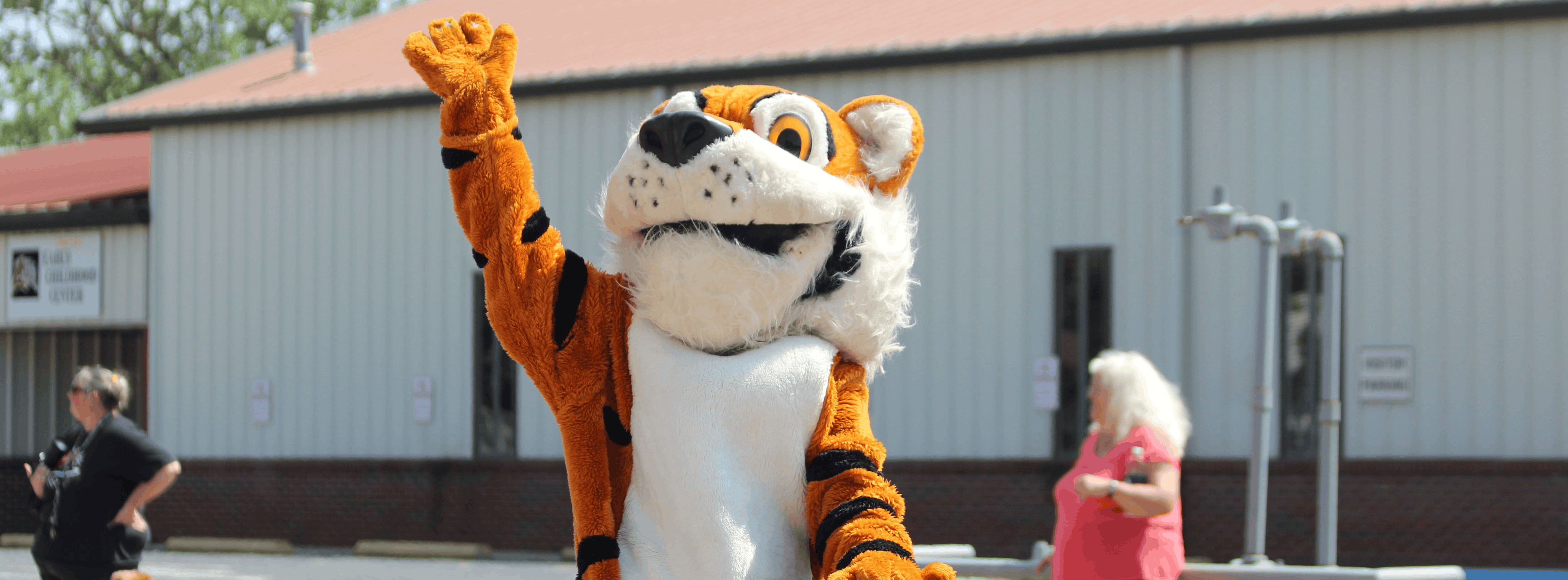 Tiger Mascot waving to community members 