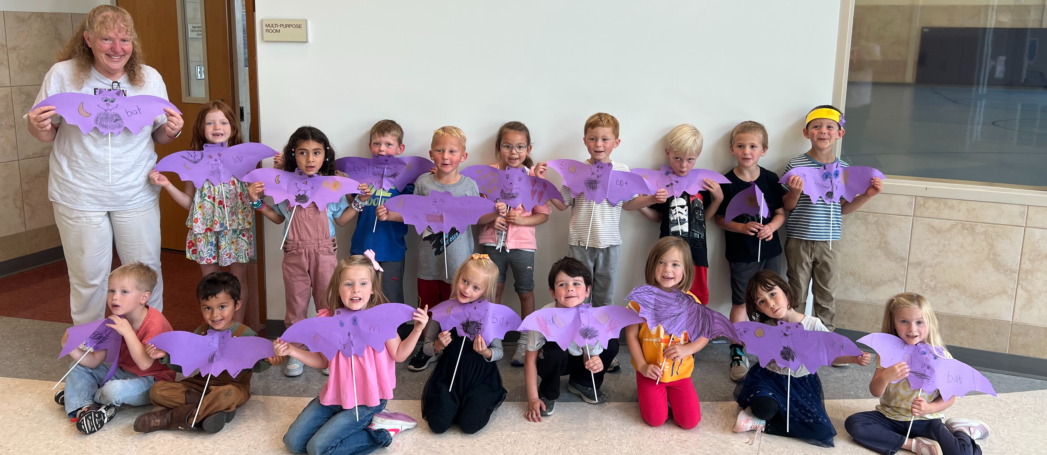 Kindergarten Students with Purples Bats They Created