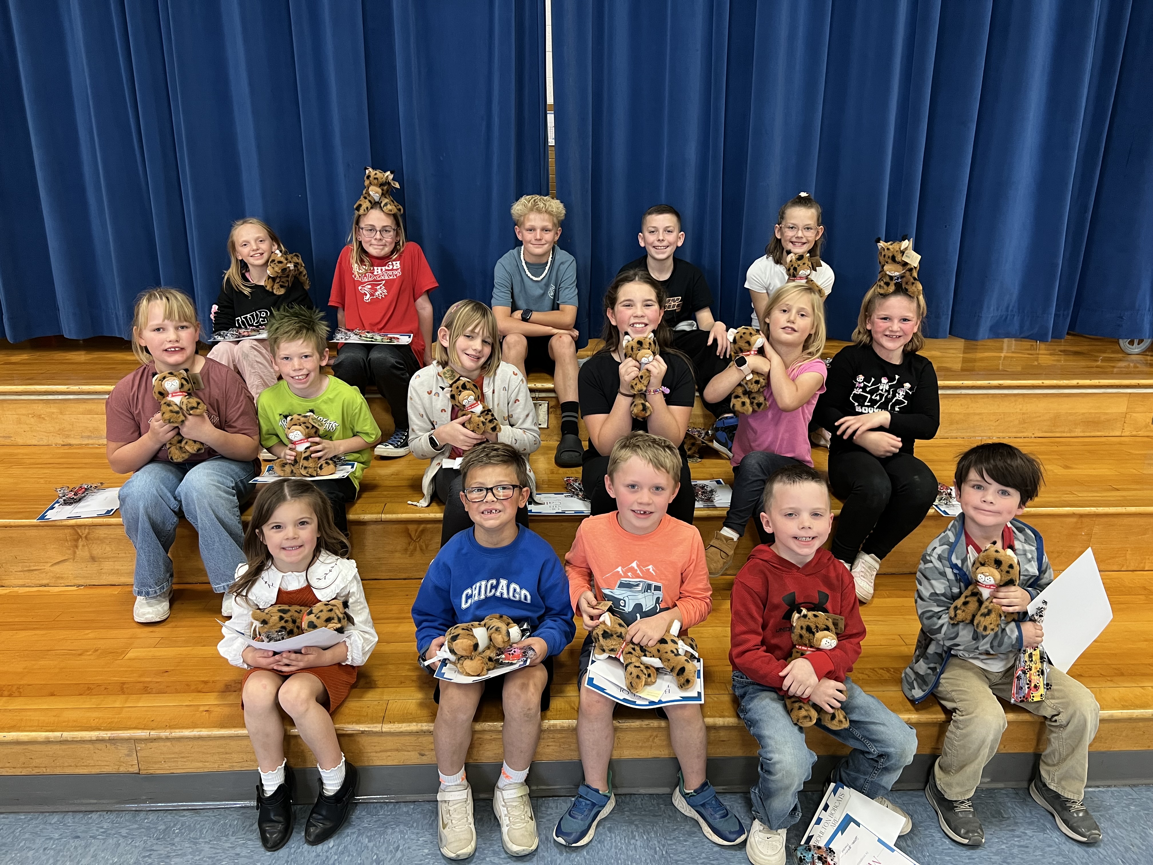 Students sitting on stage steps.