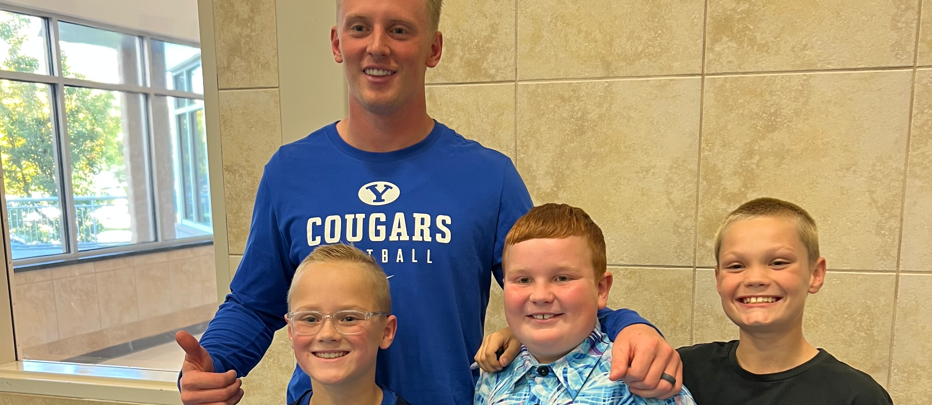 Tanner Wall, football player, with students.