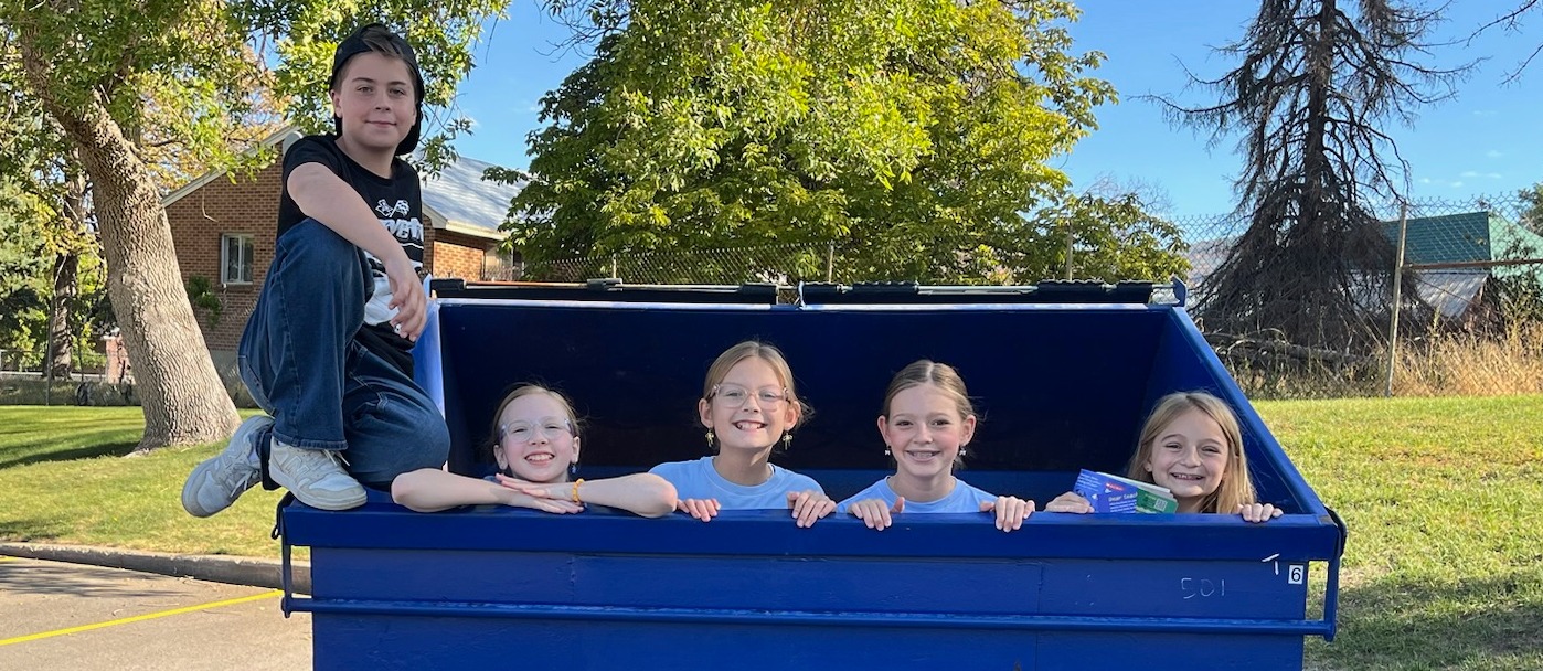 Student Council Recycling Crew in and on the recycling dumpster