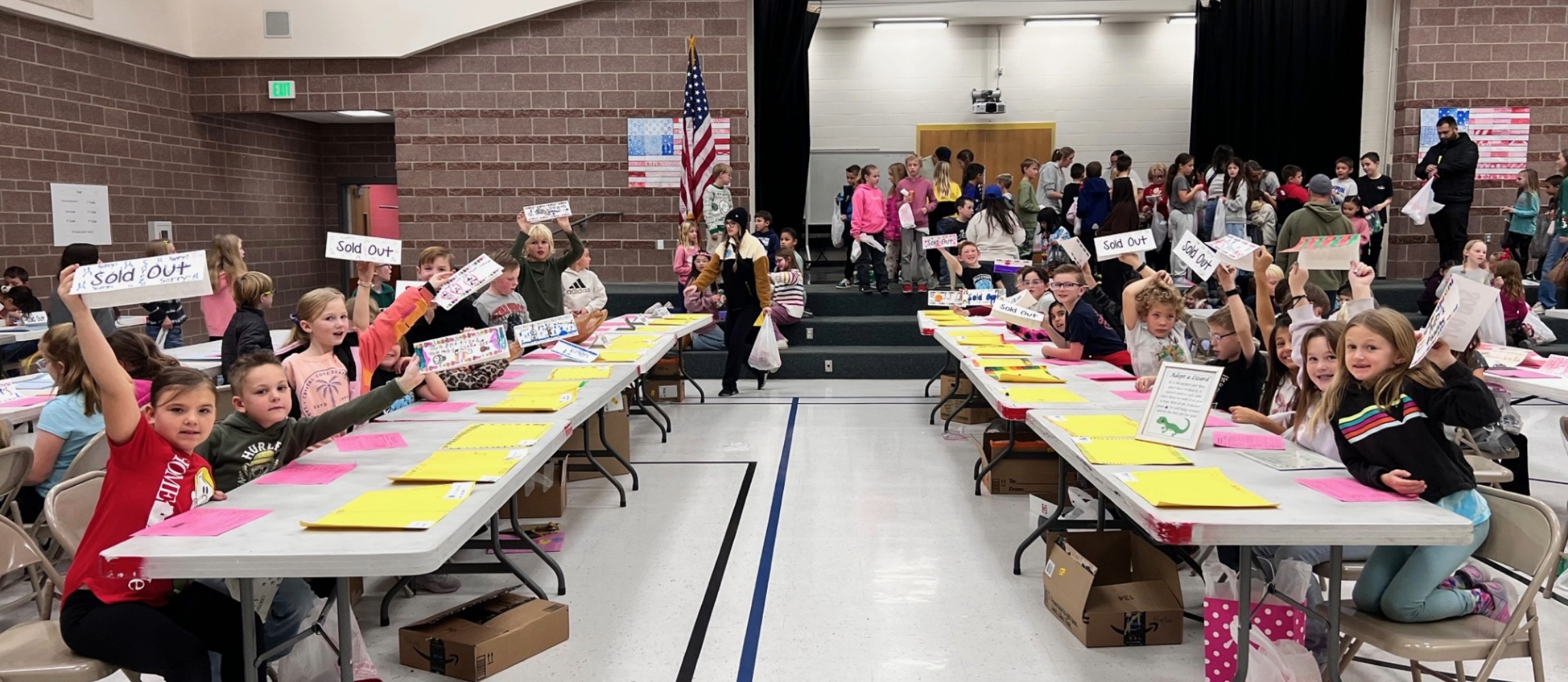 third graders at their stations for the economics fair