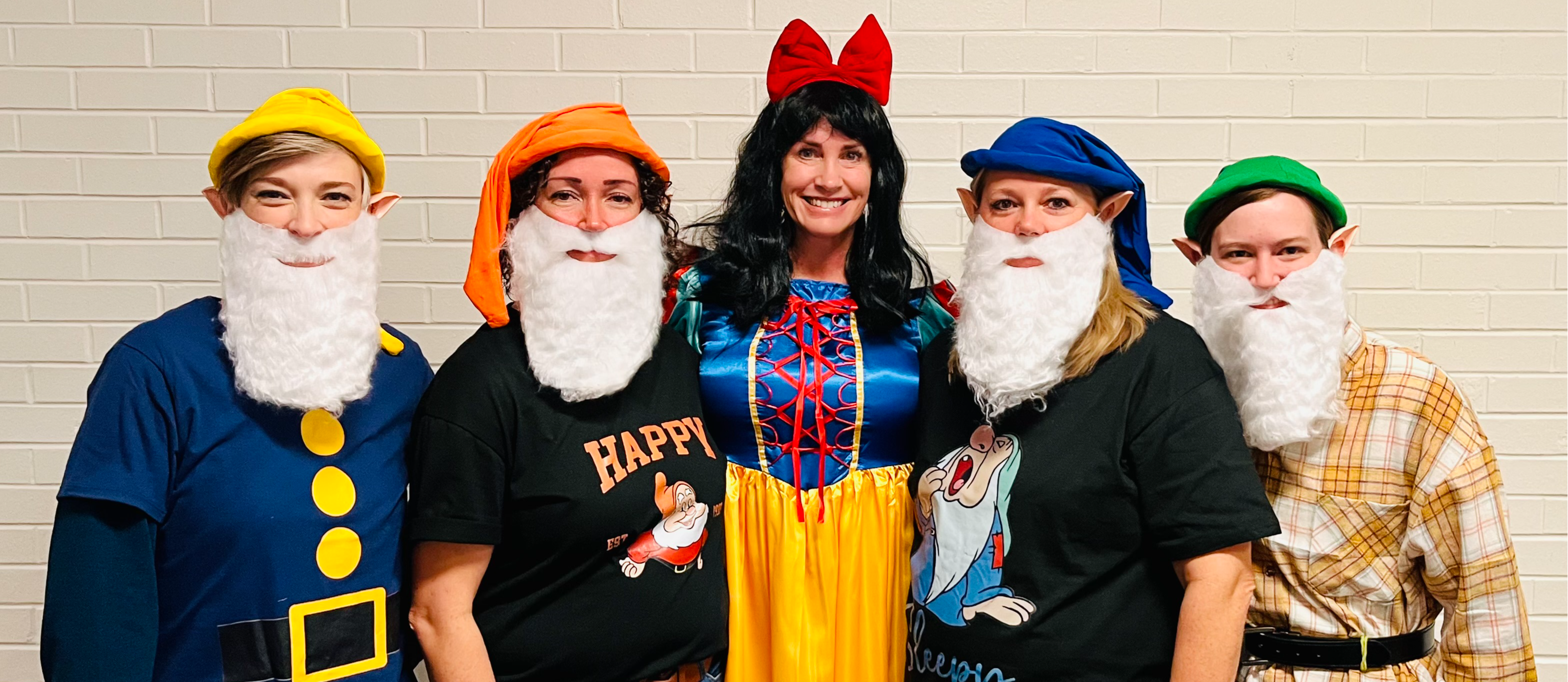 The office staff and admin dressed up as Snow White and 4 of her dwarves.