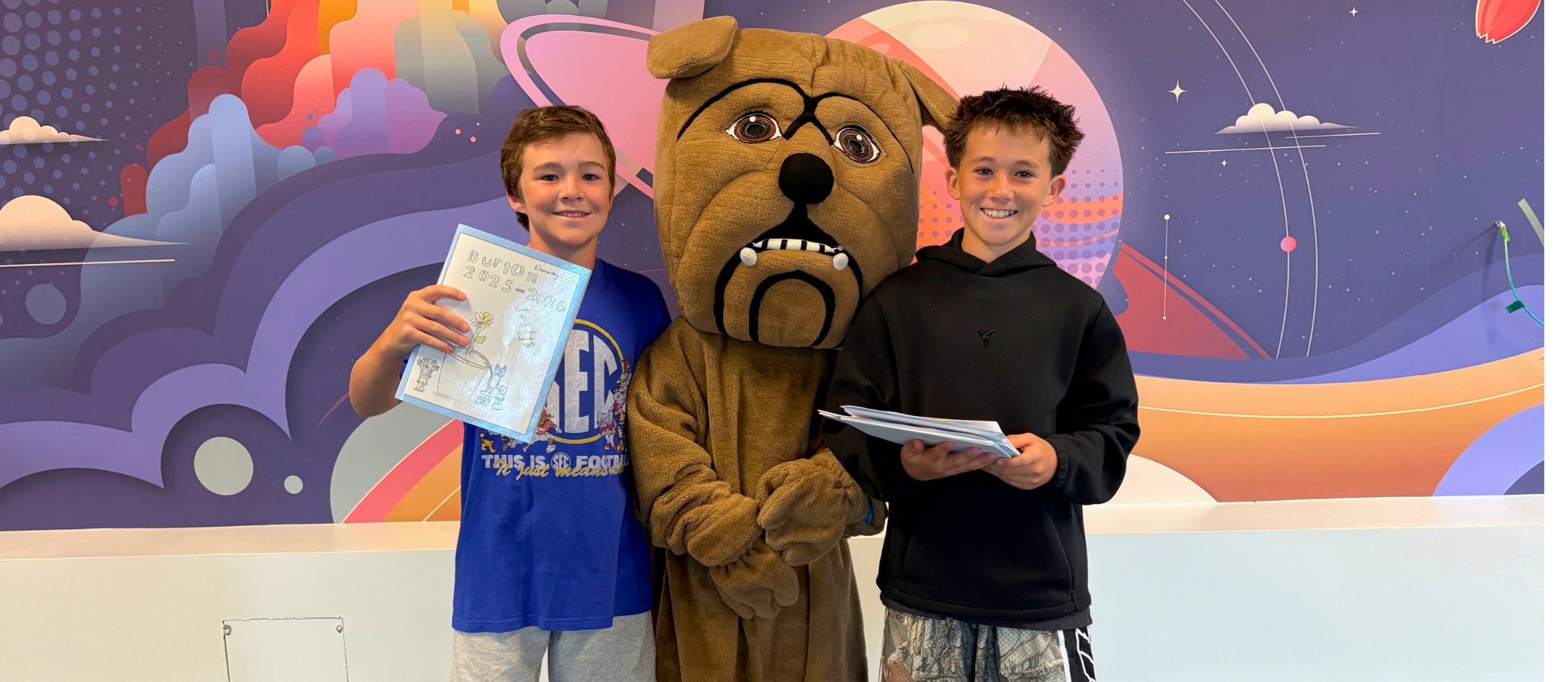 Students pose with school mascot