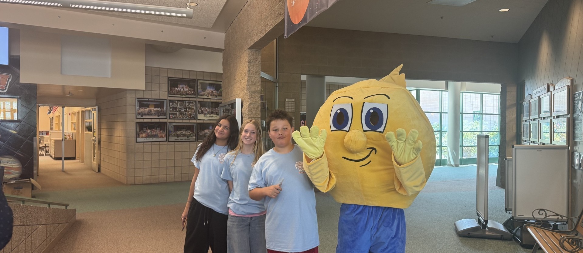 Students standing with comet school mascot