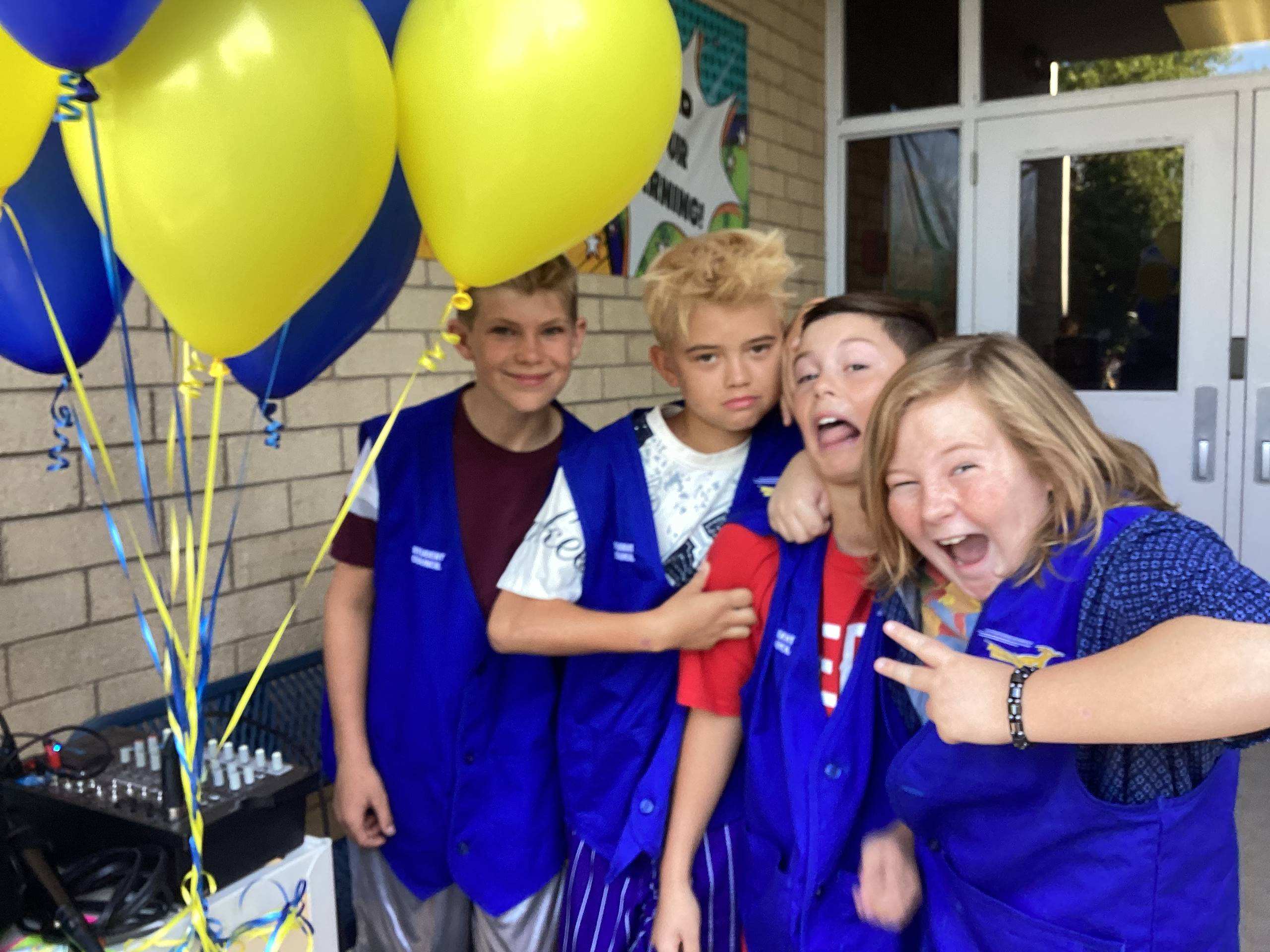 Student council members next to balloons on the first day of school.