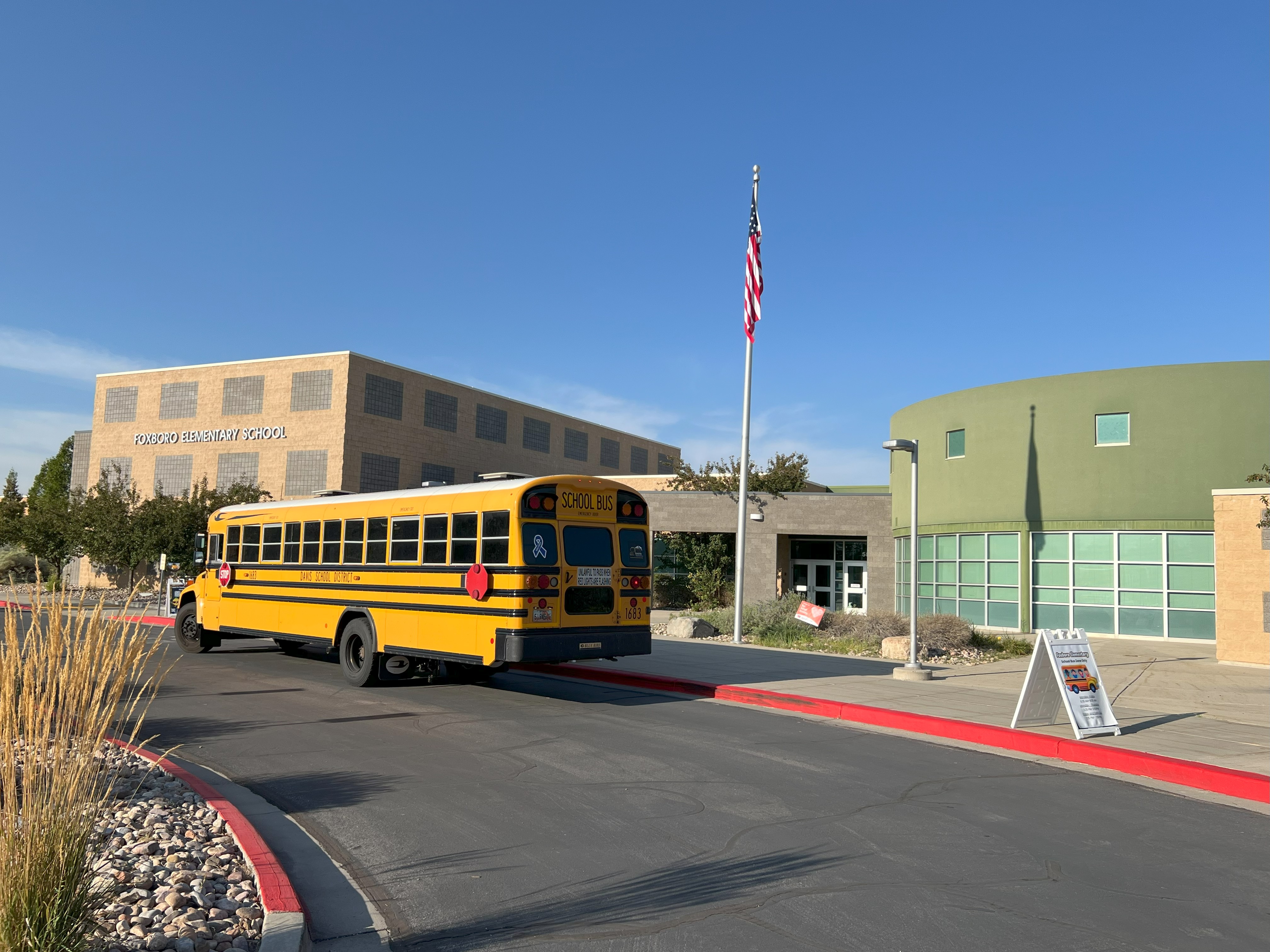 Foxboro Front of school with a school bus.