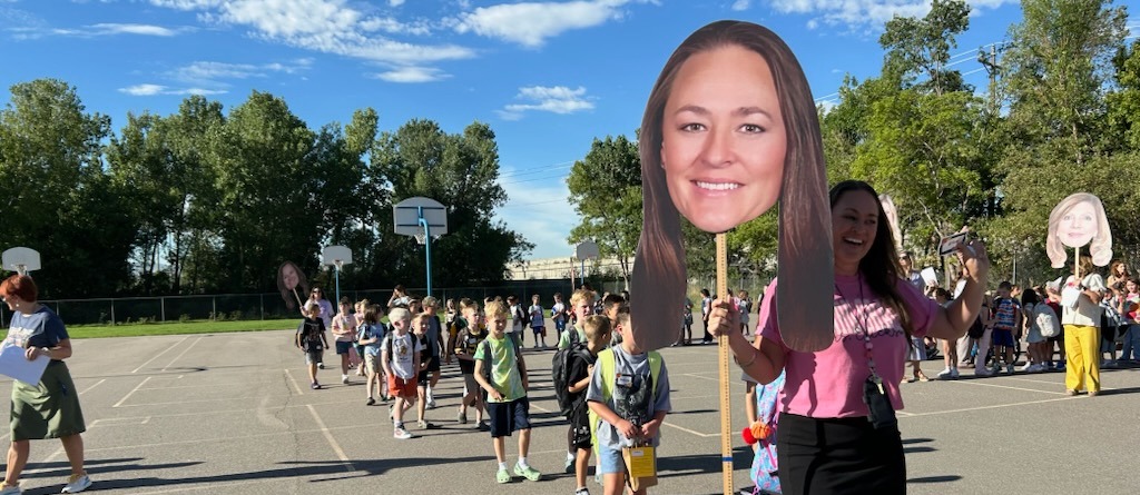 Teacher with fat head sign